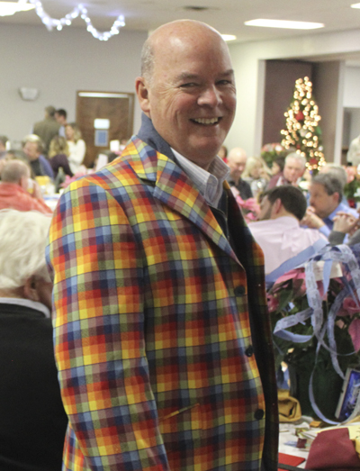 man standing in plaid jacket and smiling